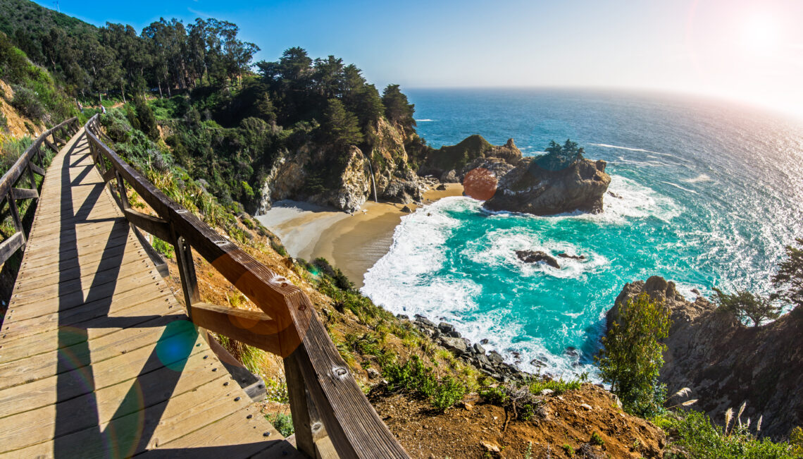 Wooden Bridge over blue water cove in Pfeiffer Park, Big Sur, CA