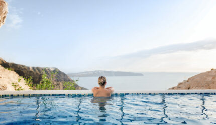 Woman in pool overlooking ocean