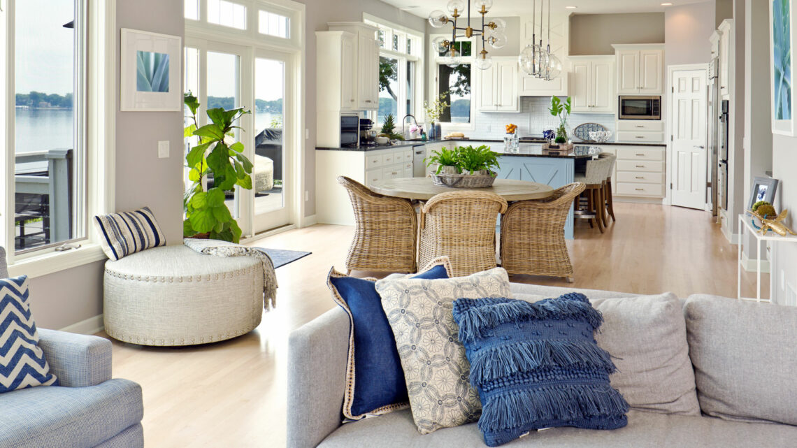 white kitchen with dining area, couch in foreground