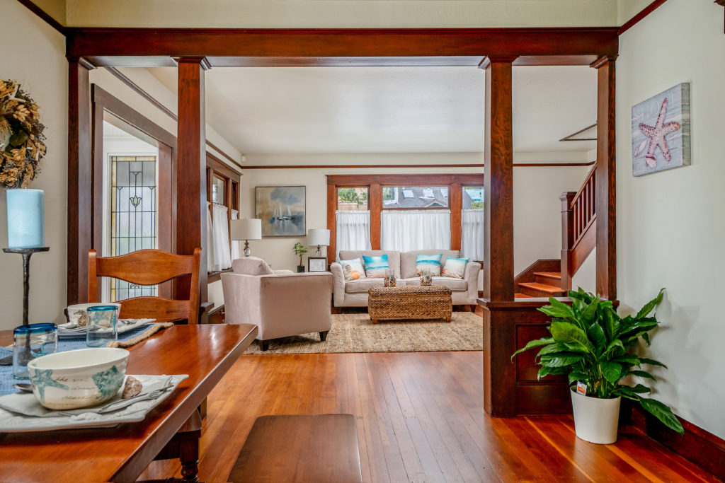 Interior living room of 1930s historic craftsman, with columns and bannister, Pacific Grove, CA